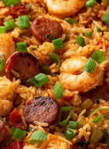 Delicious Creole Jambalaya with seafood, sausage, and colorful vegetables in a bowl.