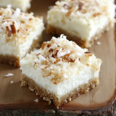 Delicious Skinny Coconut Cheesecake Bars topped with coconut flakes