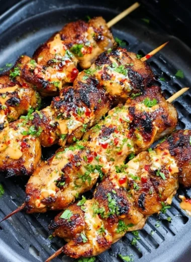 Air Fryer Bang Bang Chicken Skewers served on a plate with dipping sauce