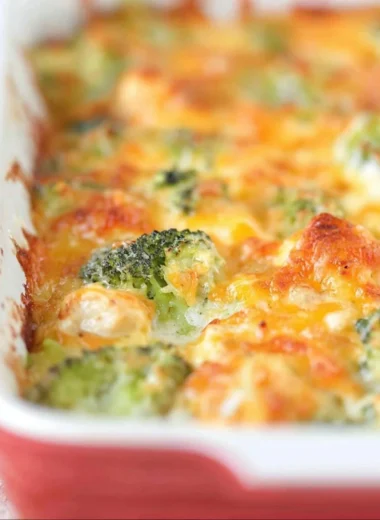 Delicious chicken broccoli bake topped with melted cheese and fresh herbs
