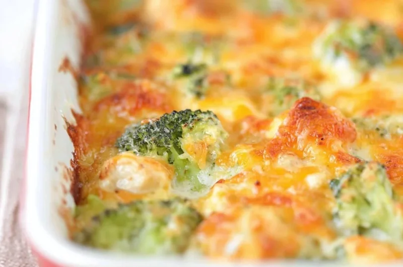 Delicious chicken broccoli bake topped with melted cheese and fresh herbs