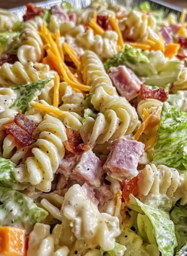 Creamy club sandwich pasta salad served in a bowl with fresh ingredients.