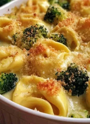 Creamy Cheesy Broccoli Tortellini Bake topped with cheese and broccoli