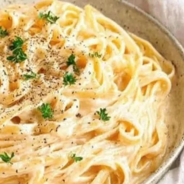 Delicious plate of creamy Fettuccine Alfredo topped with parsley