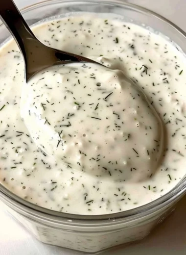 Bowl of homemade ranch dressing with fresh herbs and garlic