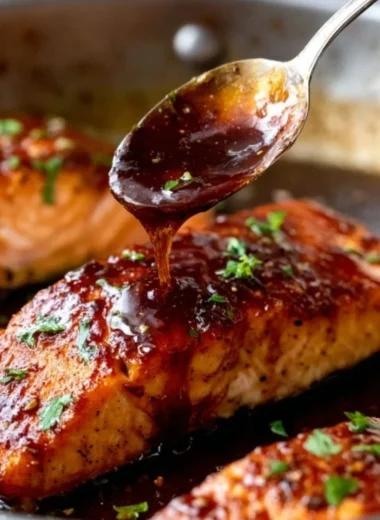Honey Garlic Salmon dish garnished with herbs on a plate.