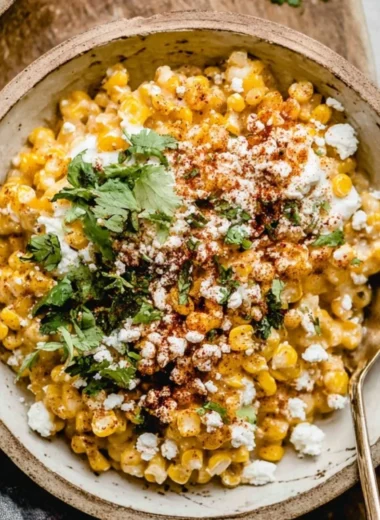 Delicious Mexican street corn casserole topped with cheese and spices