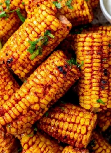 Delicious roasted corn ribs served on a plate with herbs and spices