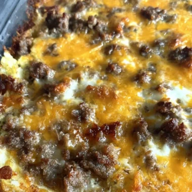 Sausage Hashbrown Breakfast Casserole topped with cheese and herbs