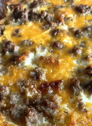 Sausage Hashbrown Breakfast Casserole topped with cheese and herbs