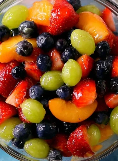 Delicious quick quiche served with fruit salad on a rustic table.