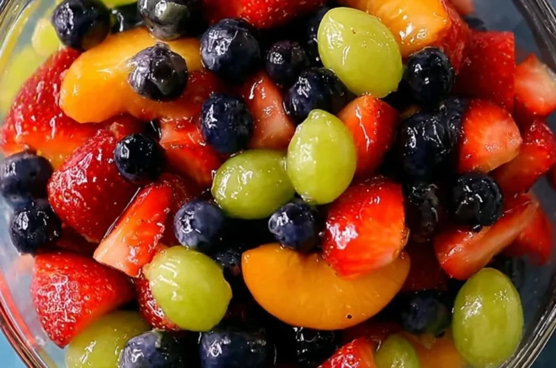 Delicious quick quiche served with fruit salad on a rustic table.