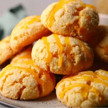 Freshly baked tropical mango cookies with pieces of mango on a plate.