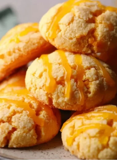 Freshly baked tropical mango cookies with pieces of mango on a plate.