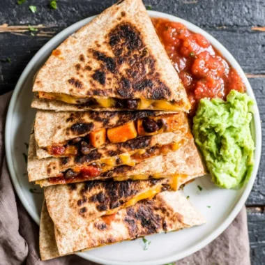 Delicious Black Bean Sweet Potato Quesadilla served with salsa and garnished.
