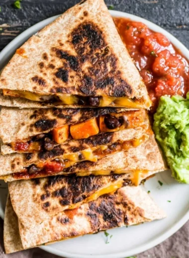 Delicious Black Bean Sweet Potato Quesadilla served with salsa and garnished.