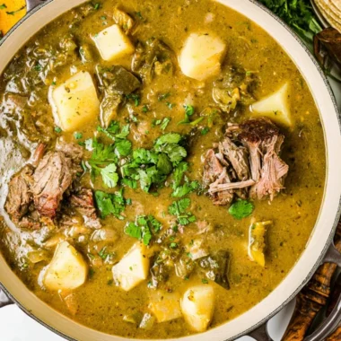 A bowl of homemade broth with herbs and vegetables
