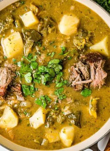 A bowl of homemade broth with herbs and vegetables