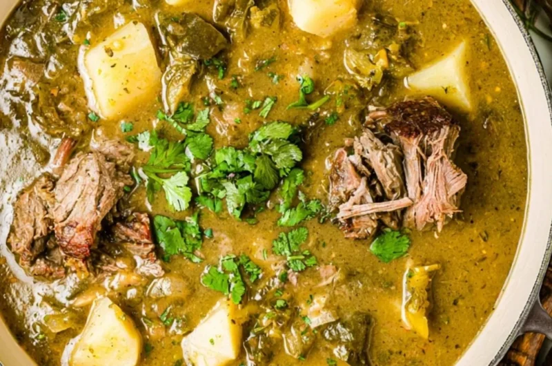 A bowl of homemade broth with herbs and vegetables
