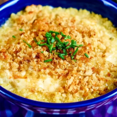 Cheesy Quinoa Mac and Cheese topped with herbs in a baking dish