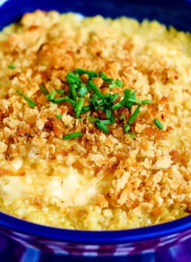 Cheesy Quinoa Mac and Cheese topped with herbs in a baking dish