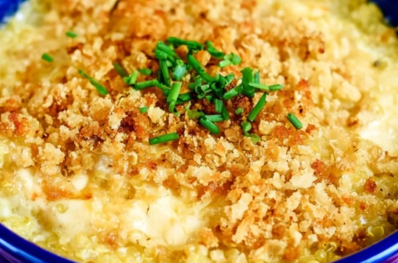 Cheesy Quinoa Mac and Cheese topped with herbs in a baking dish