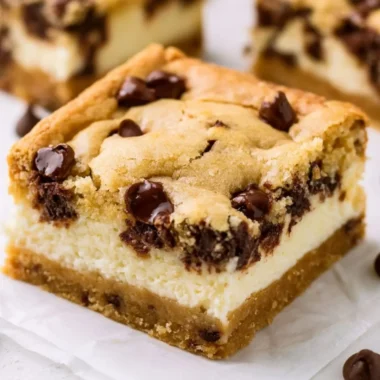 Delicious chocolate chip cheesecake bars topped with chocolate chips