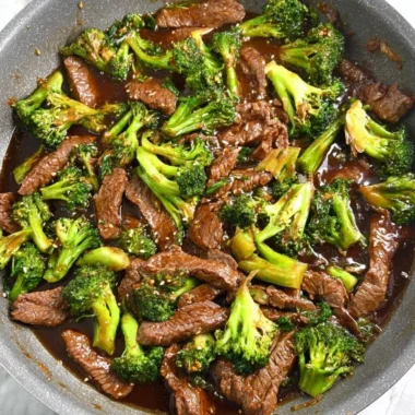 Gluten-free beef and broccoli served on a plate with vibrant vegetables