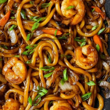 Plate of grilled udon noodles with vegetables and sauce