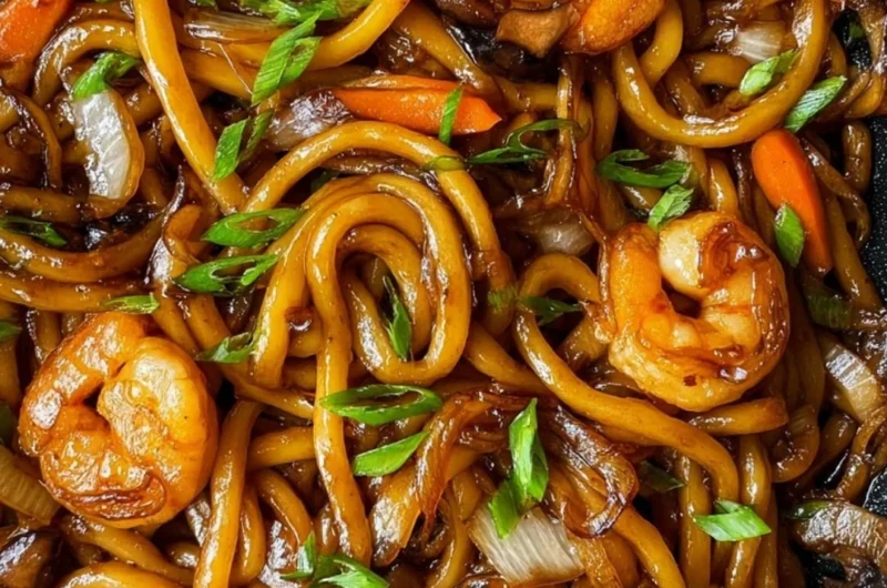 Plate of grilled udon noodles with vegetables and sauce