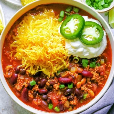 Healthy turkey chili in a bowl garnished with fresh herbs