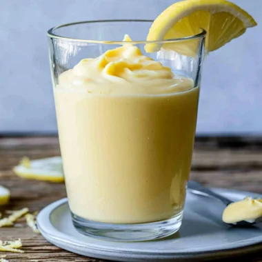 Delicious Lemon Cream dessert topped with fresh lemon zest and mint leaves
