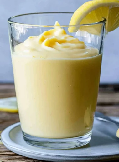 Delicious Lemon Cream dessert topped with fresh lemon zest and mint leaves