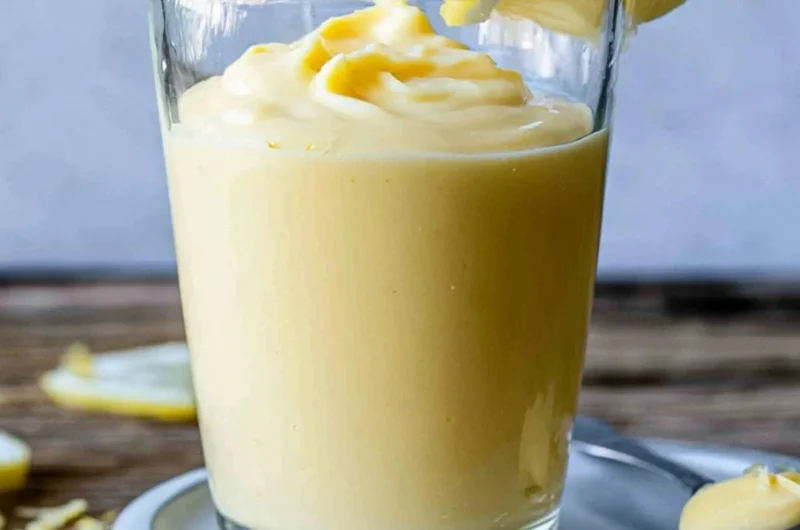 Delicious Lemon Cream dessert topped with fresh lemon zest and mint leaves