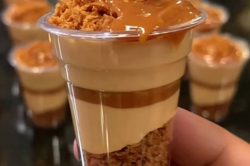 Mini Biscoff cheesecake cups topped with creamy Biscoff spread and crumbs.