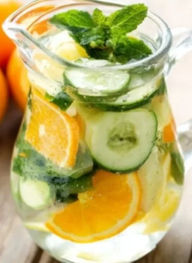 Refreshing Orange Cucumber and Mint Water served in a glass