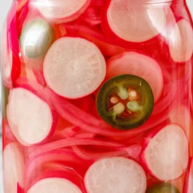 Jars of quick pickled radishes ready to serve, showcasing vibrant colors and texture.