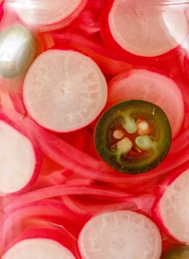 Jars of quick pickled radishes ready to serve, showcasing vibrant colors and texture.