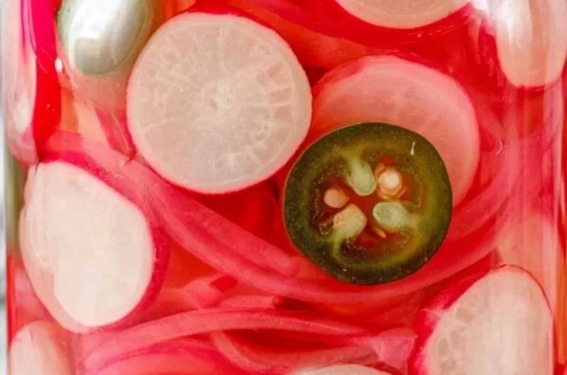 Jars of quick pickled radishes ready to serve, showcasing vibrant colors and texture.