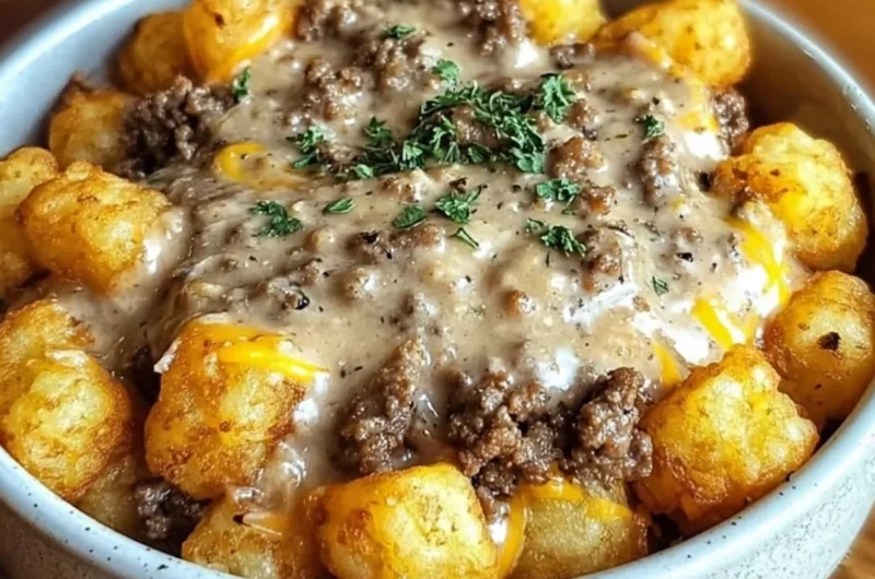 Delicious Tater Tot Breakfast Bowl with sausage gravy and toppings