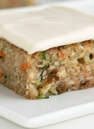 Delicious homemade zucchini bars displayed on a plate with frosting