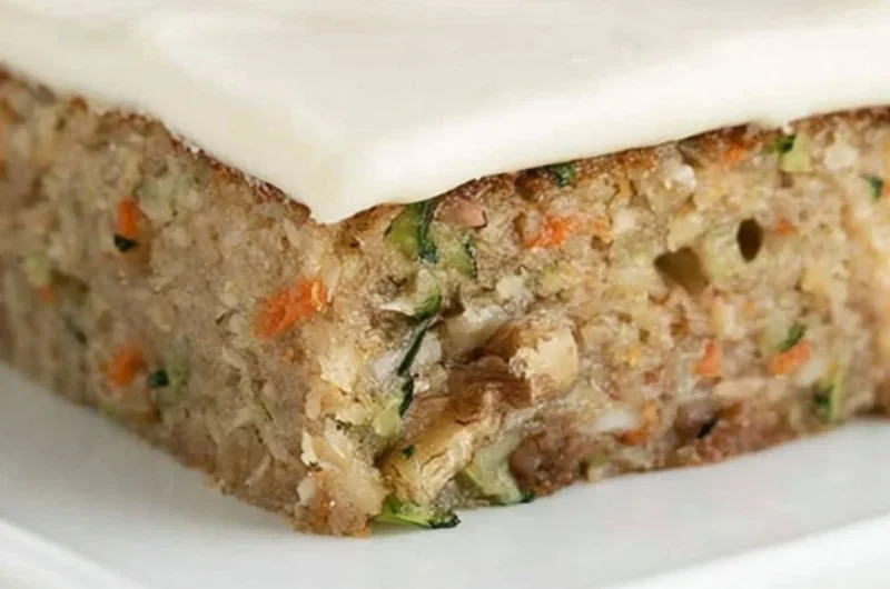 Delicious homemade zucchini bars displayed on a plate with frosting