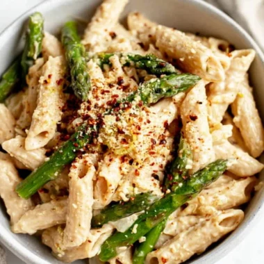 Vegan Lemon White Bean Pasta dish garnished with fresh herbs.
