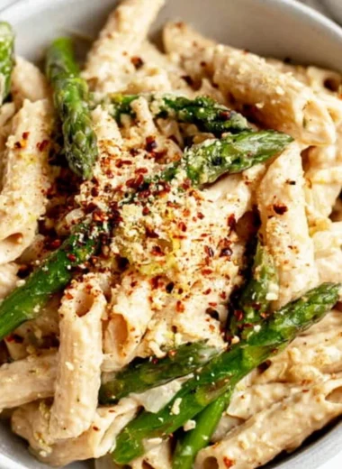 Vegan Lemon White Bean Pasta dish garnished with fresh herbs.