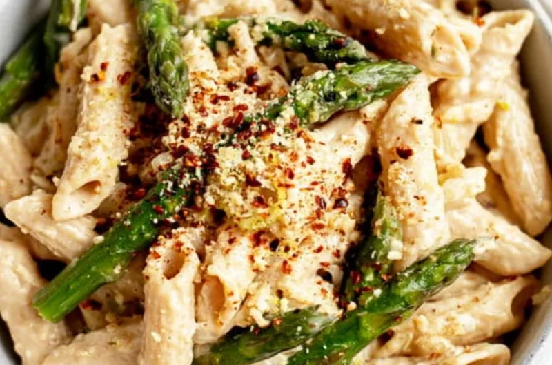 Vegan Lemon White Bean Pasta dish garnished with fresh herbs.