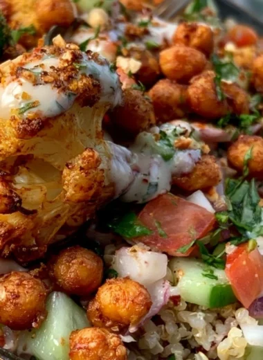 Cozy cauliflower shawarma bowl topped with fresh herbs and tahini sauce