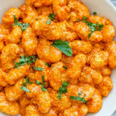 Cozy gnocchi served with garlic cream tomato sauce in a rustic bowl
