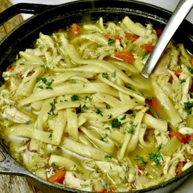 Bowl of cozy homemade chicken noodle soup with vegetables and noodles