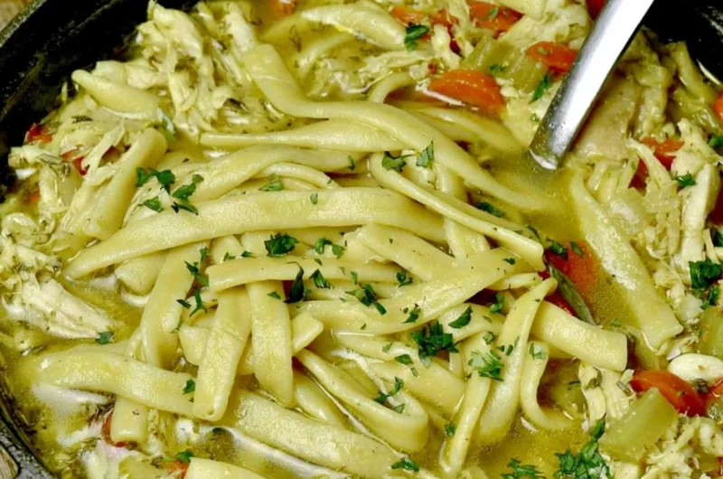 Bowl of cozy homemade chicken noodle soup with vegetables and noodles