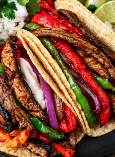Cozy Portobello vegan fajitas served with colorful peppers and onions.